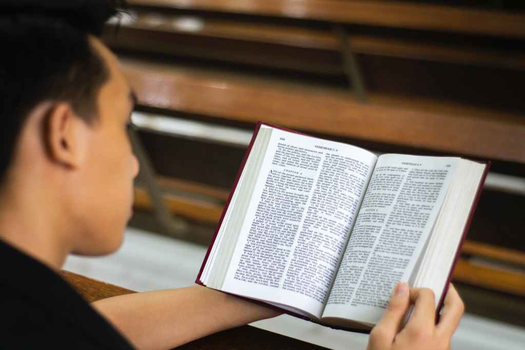 man reading a bible