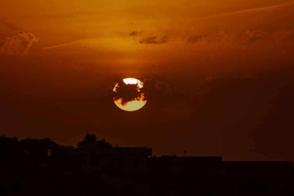 bright sun shining over dark sky