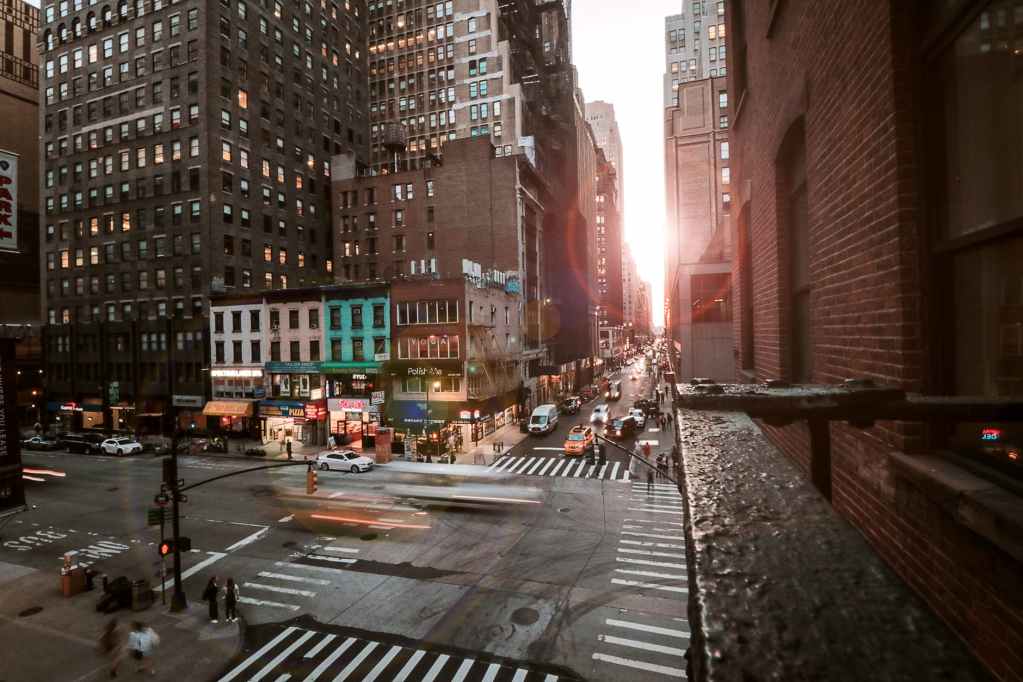 cars on road between high rise buildings