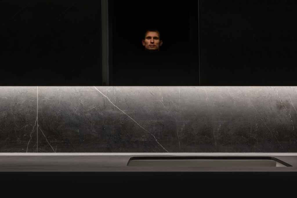 serious man in dark room at home