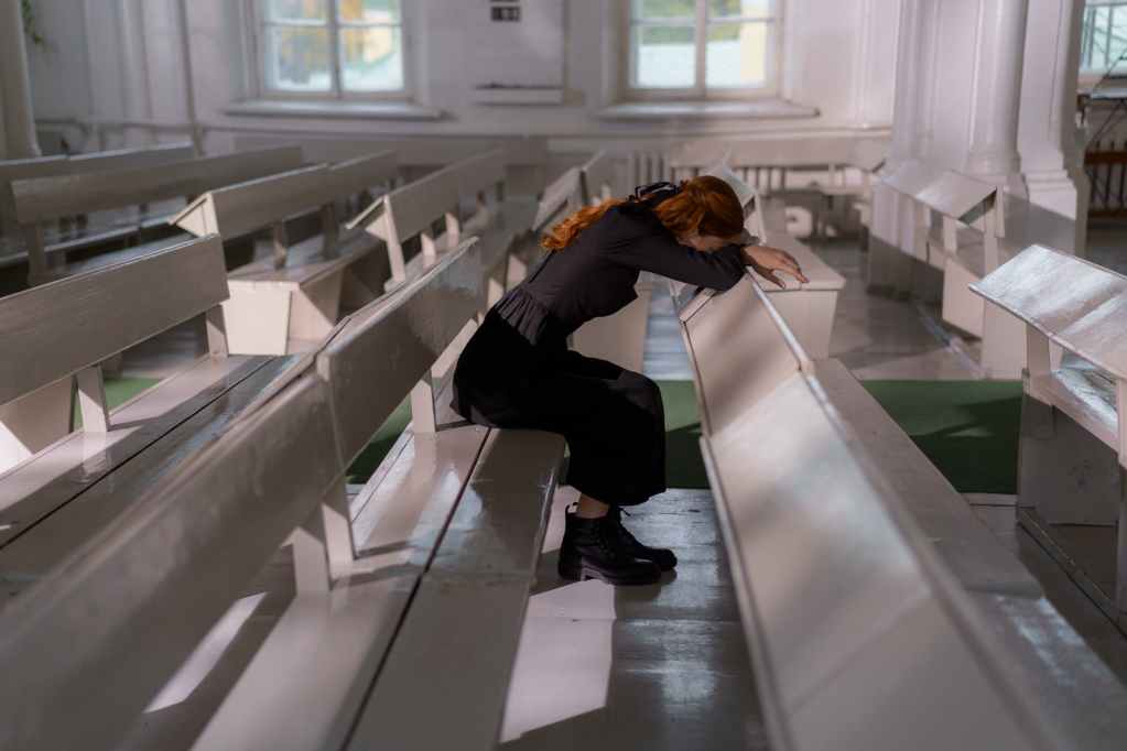 woman in black jacket and black pants sitting on white staircase