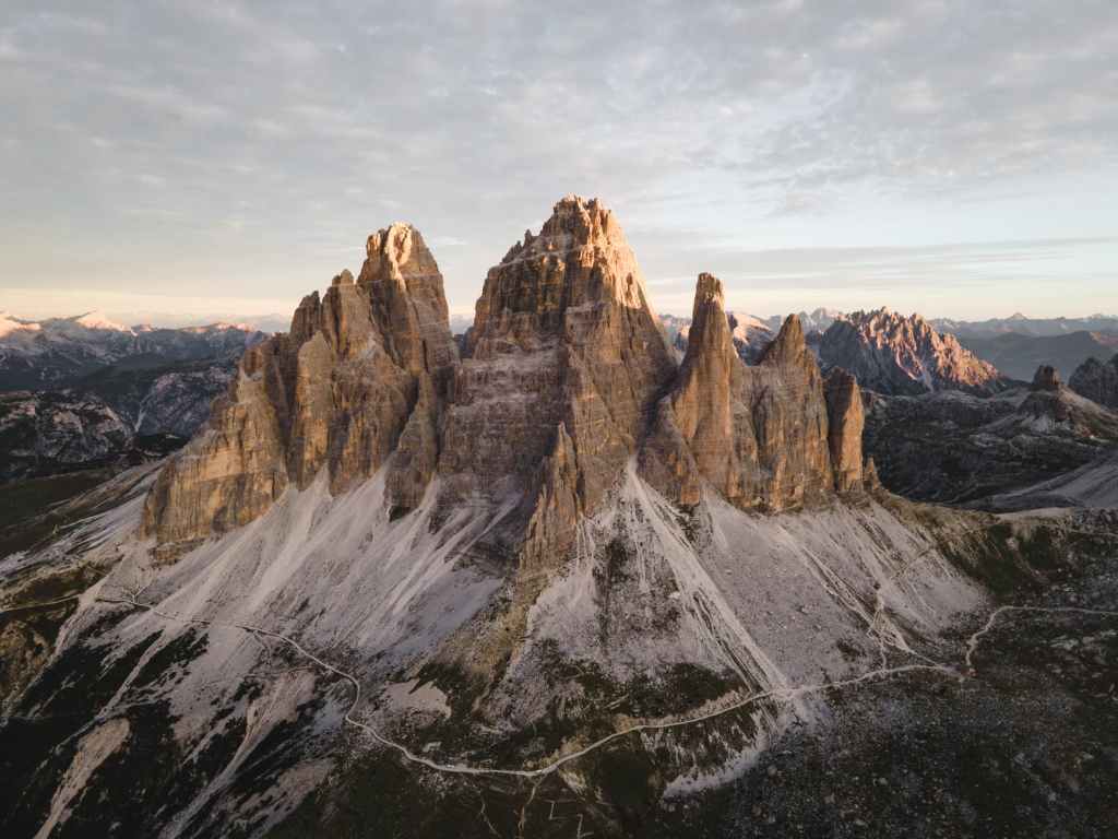 brown rocky mountain under white clouds