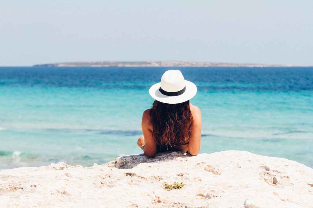 woman lying on white sand beach