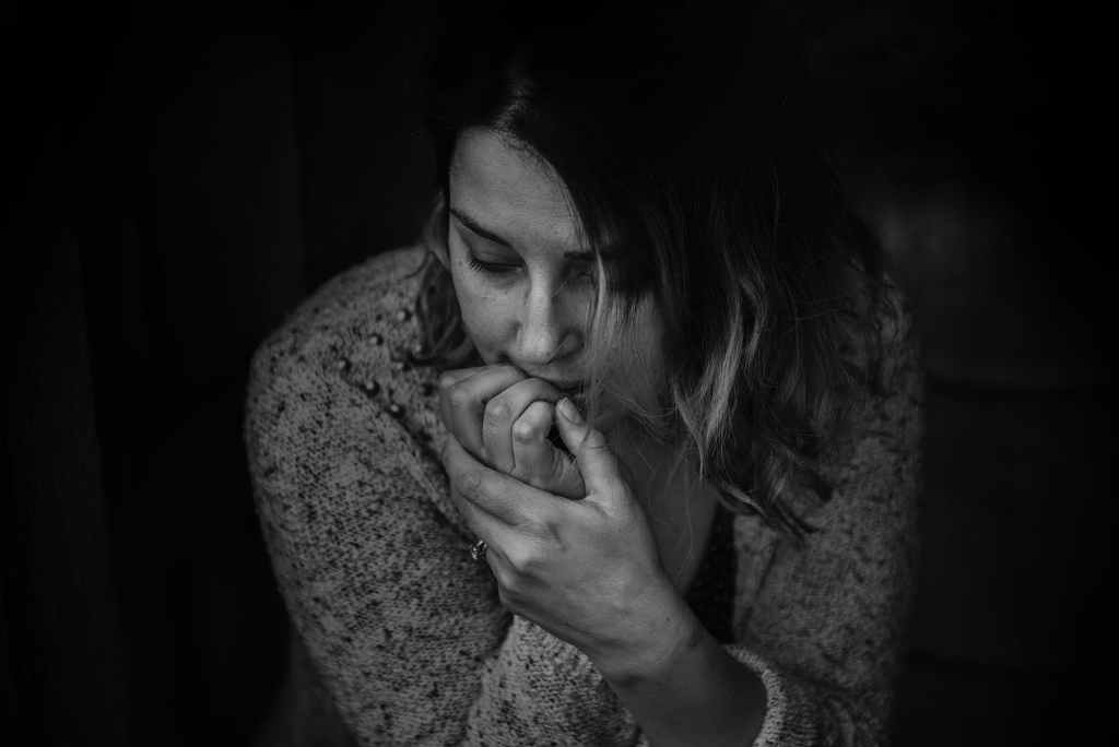 greyscale photography of woman wearing long sleeved top
