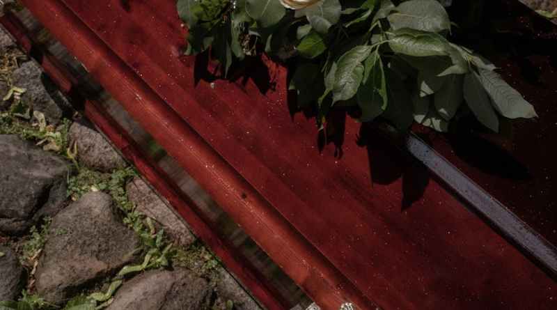 white flowers on the top of a coffin