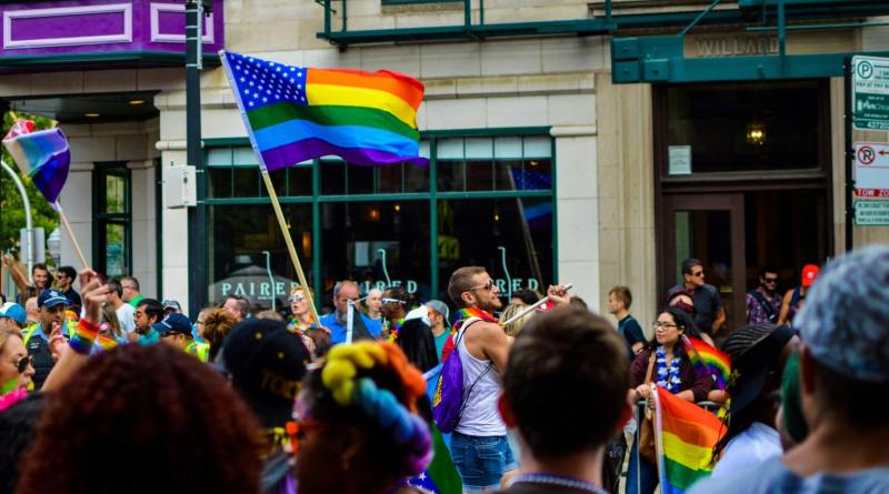 people gathered near building holding flag at daytime