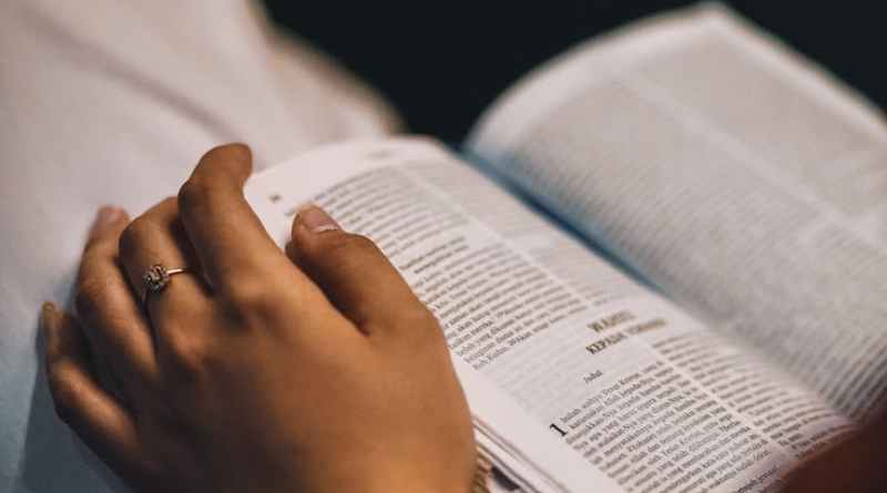 close up of a person reading a bible